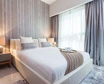 Bedroom in soft grey with full-height curtains