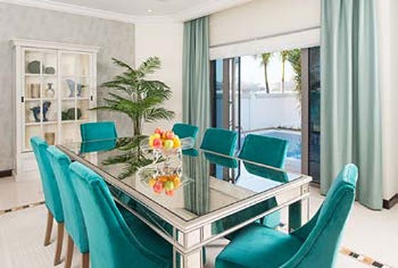 Mirrored dining table with teal velvet chairs