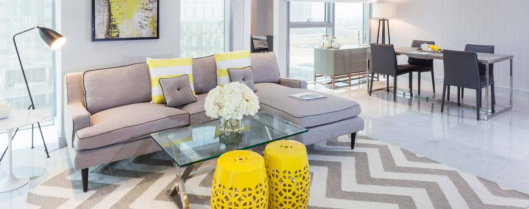 A bright Nasma living room with floor-to-ceiling windows